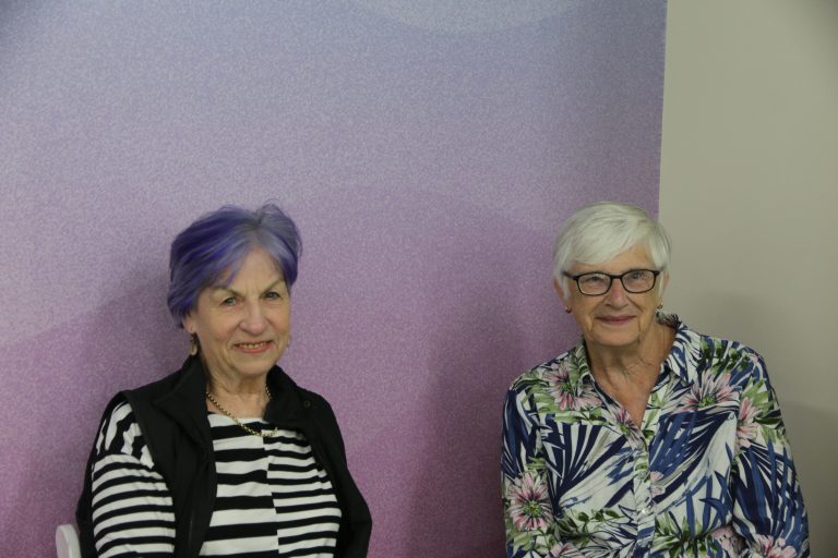 Two women interested to learn more about aged care smiling at the camera in the Wendouree office
